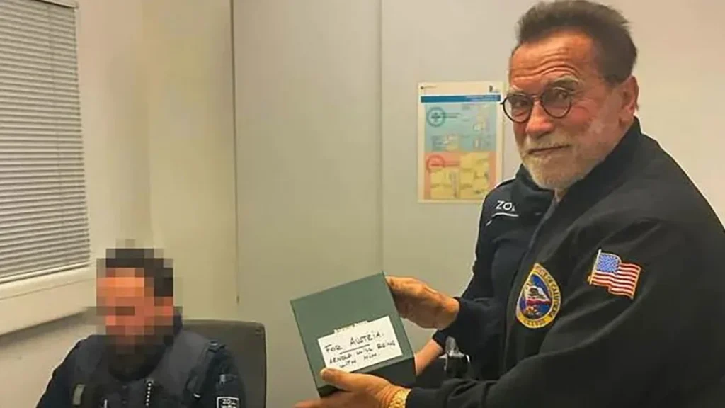 Arnold Schwarzenegger with customs agents examine a luxury watch